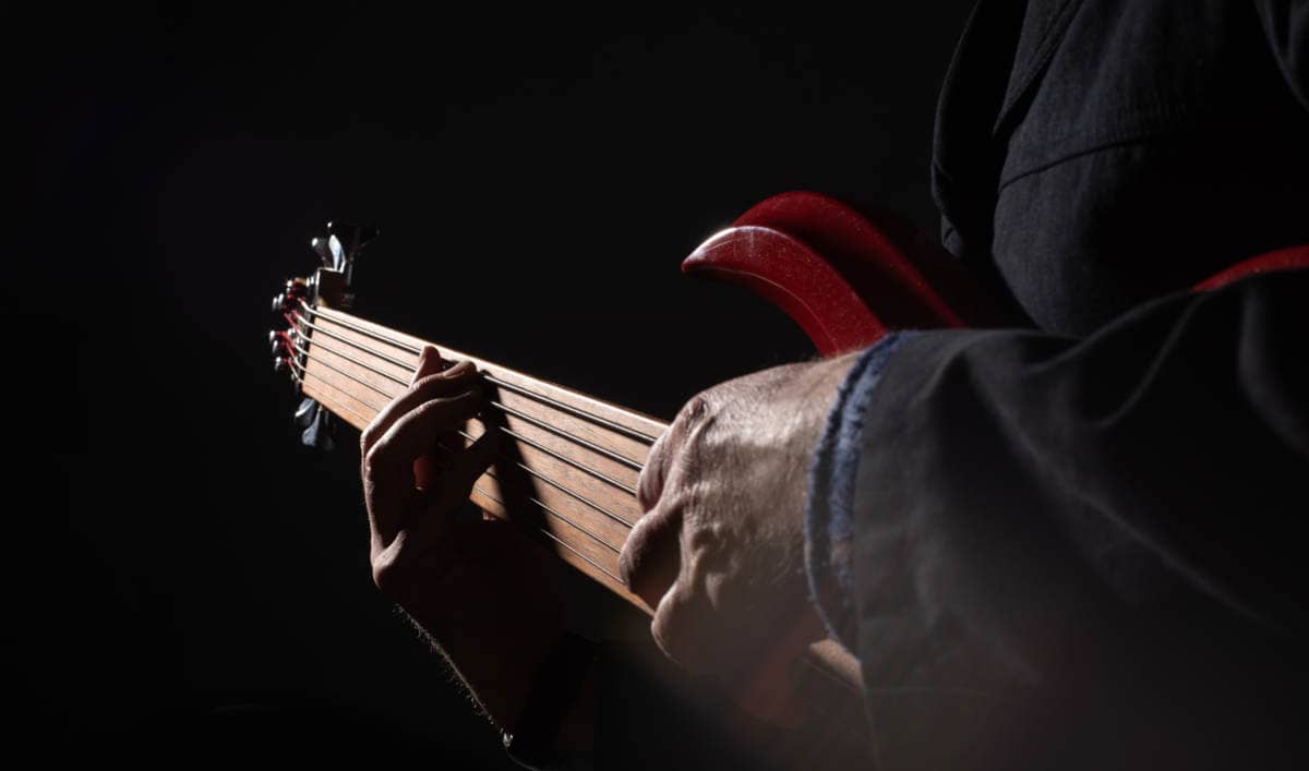 6-string bass being played in the dark
