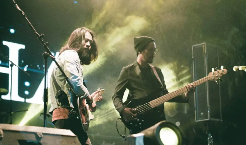 bass and guitar being played side by side on stage