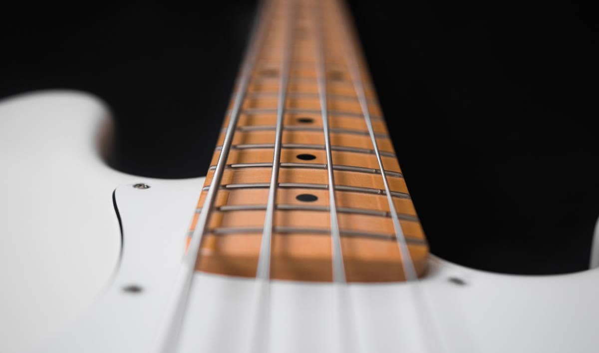bass guitar with high action seen from bottom of neck