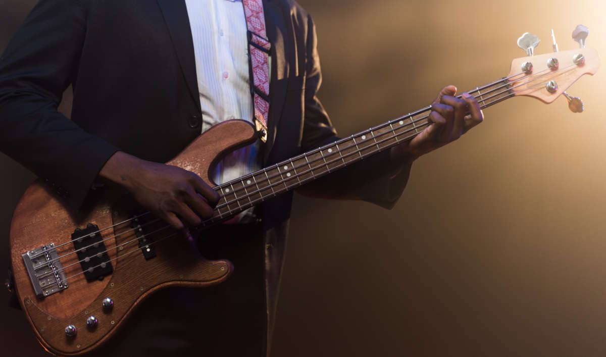 bassist in dress playing bass guitar