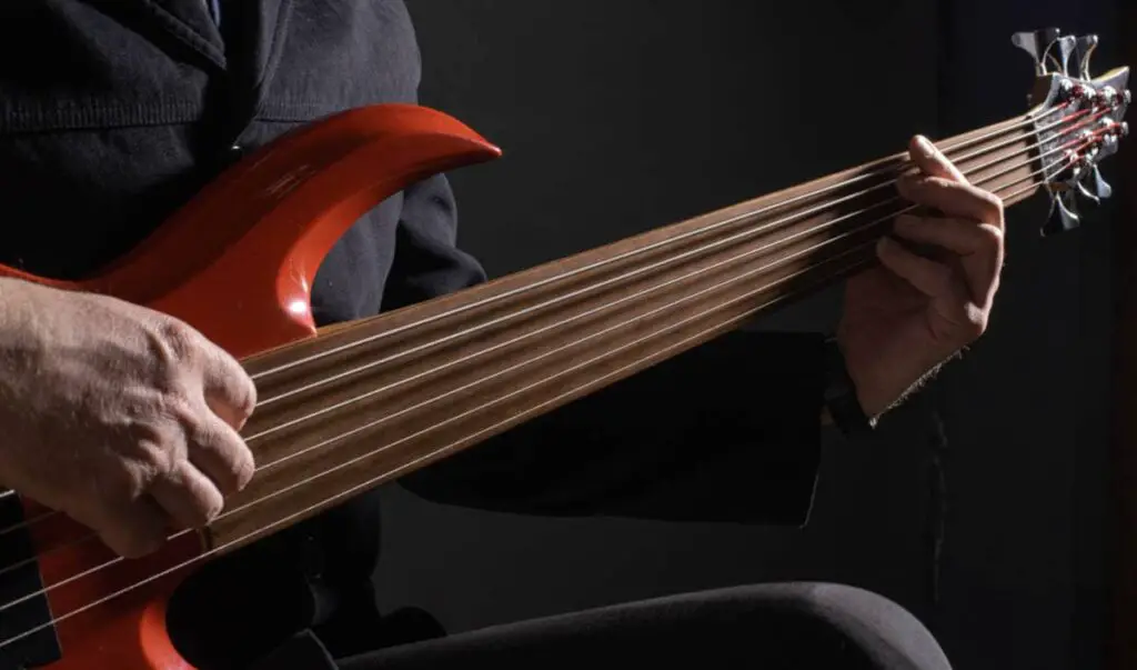 bassist playing 6-string bass