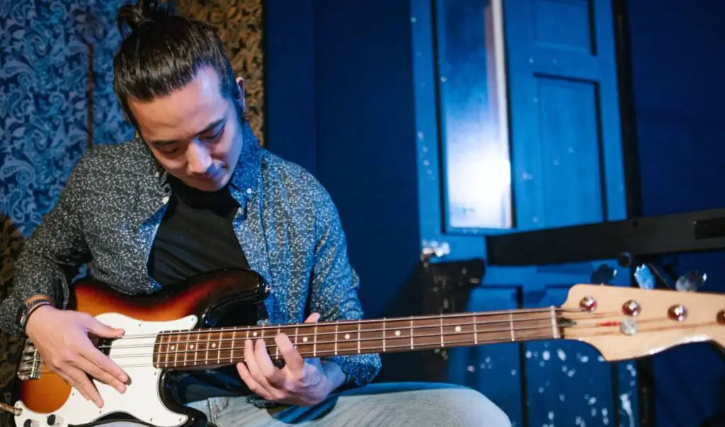 guitarist practicing chords on the bass guitar