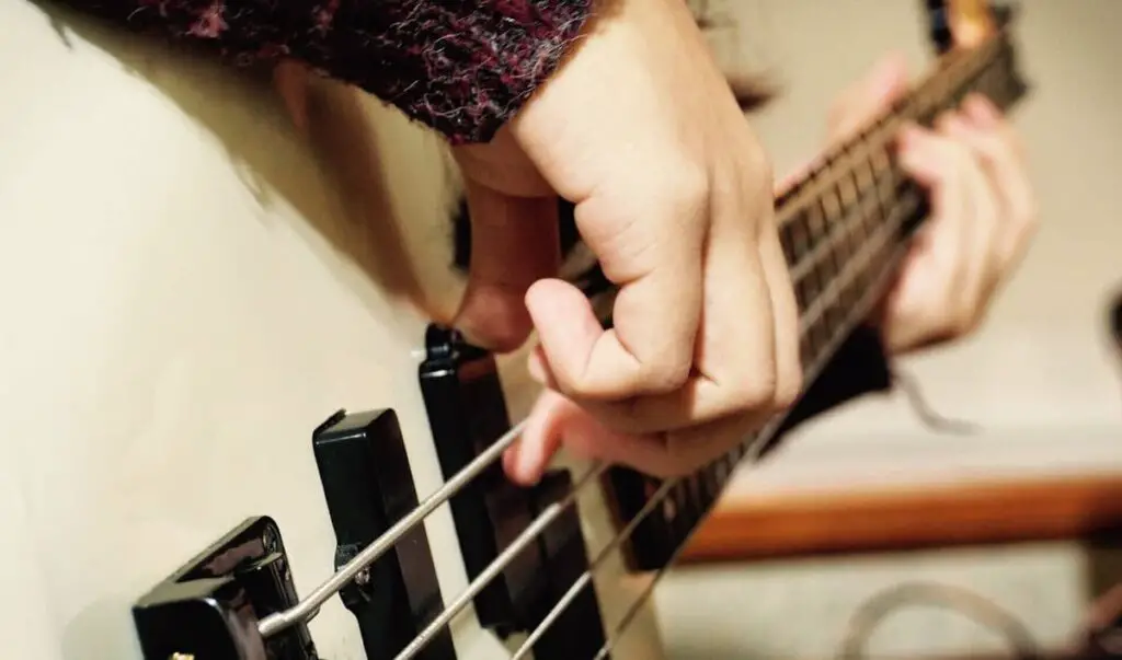 bassist practicing fingerstyle technique