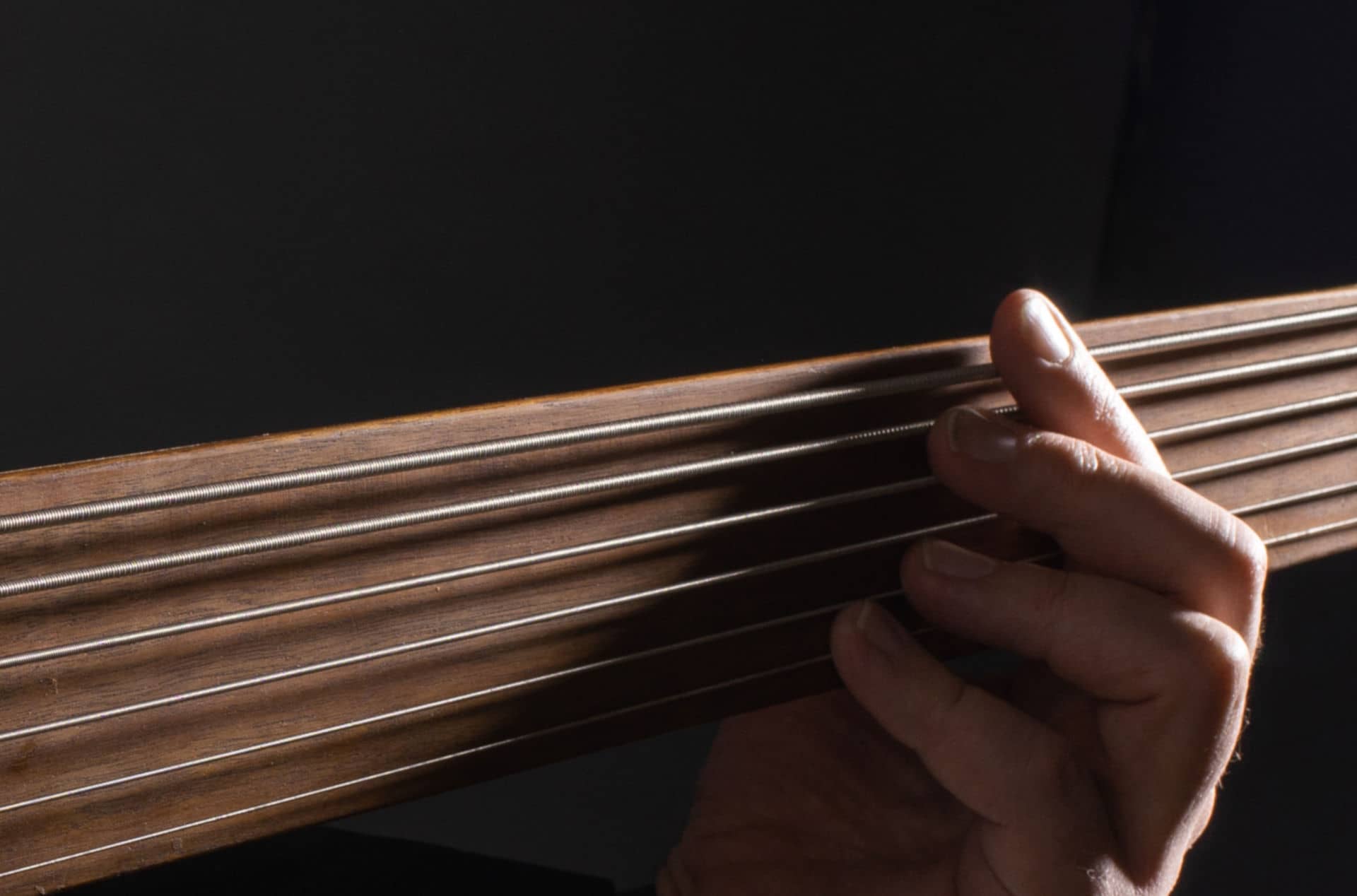 fretless bass guitar being played