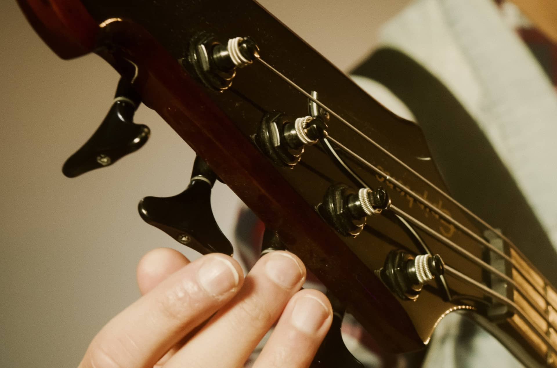 bass guitar being tuned to a standard