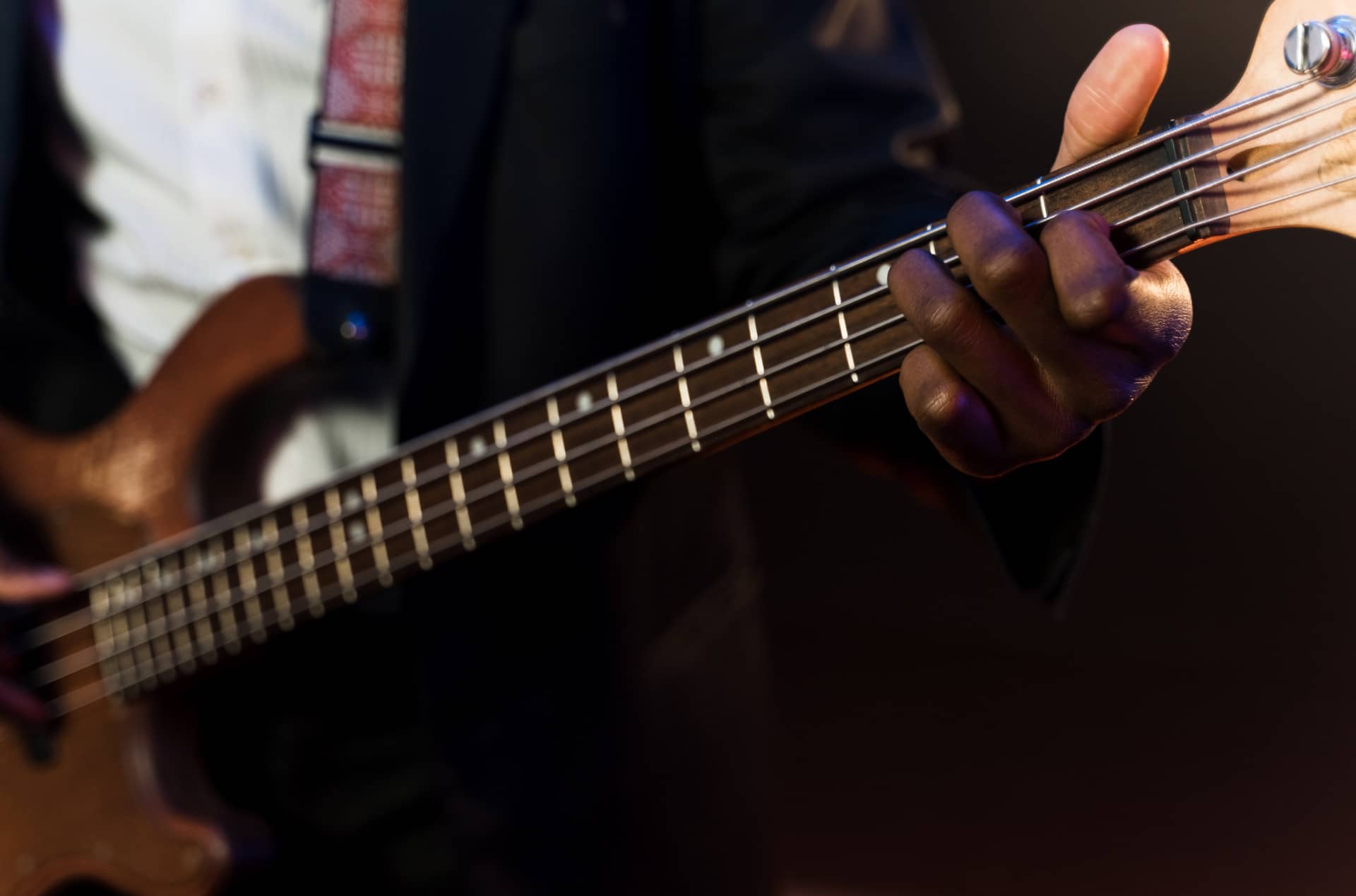 bassist playing thin 4-string bass with fast neck