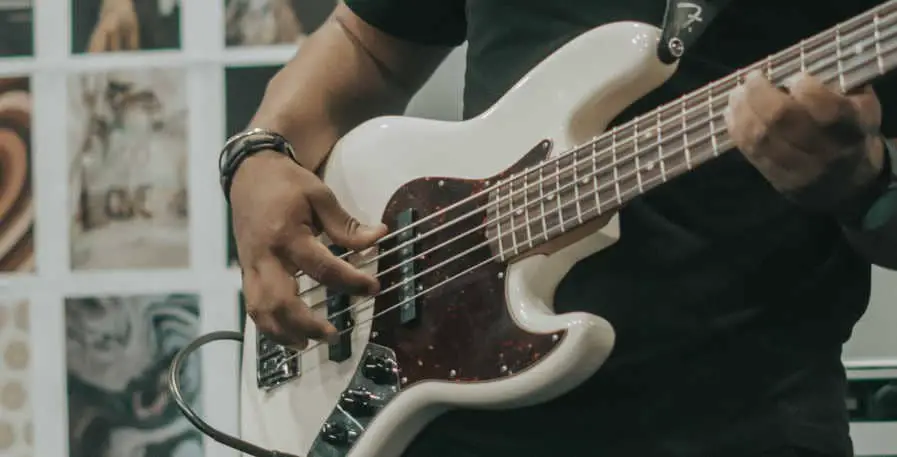 5-string bass being played with 3 finger plucking technique