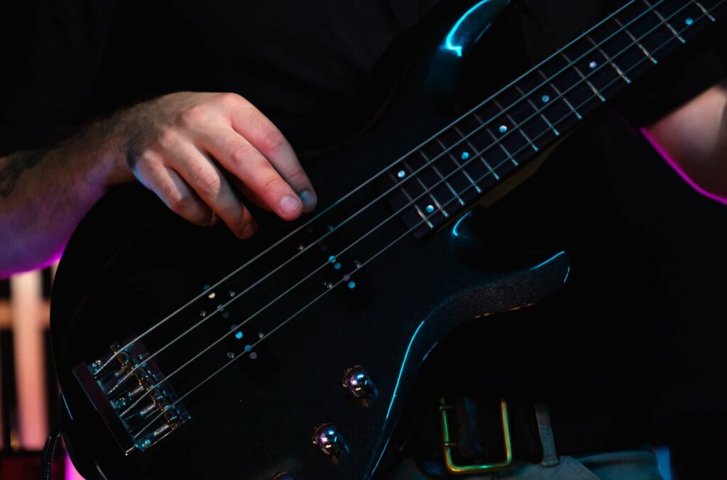 fingerstyle bass player playing a 4-string bass guitar