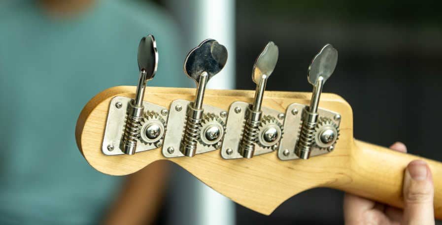 tuning pegs on a 4-string bass guitar