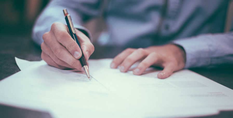 man signing insurance plan