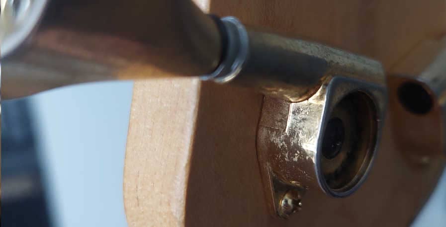 opened tuning peg on back of bass headstock