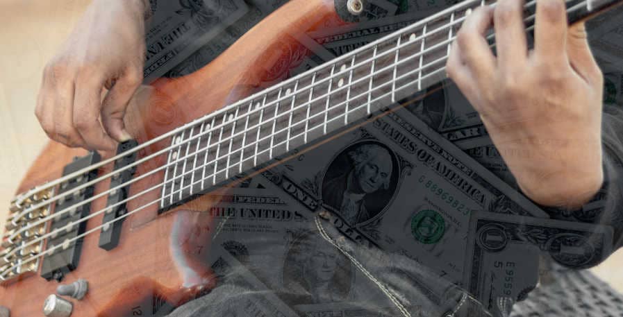 5-string bass guitar and dollar bills on top of one another