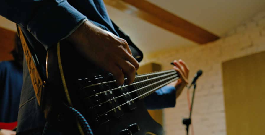 bassist playing bass with flatwound strings