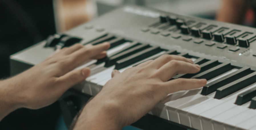 keyboardist playing bass on a keyboard