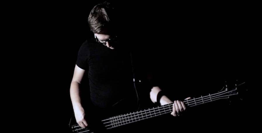 sad bass player playing a bass with neck dive