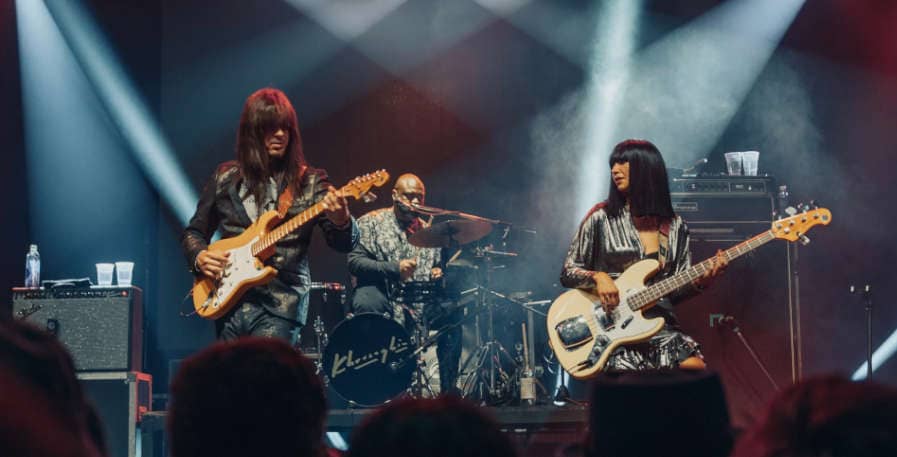 guitarist and bassist playing rock music on stage