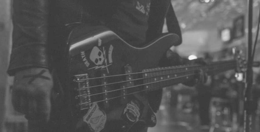 punk bass player holding a 4-string