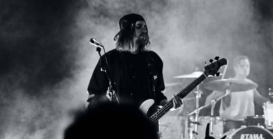 bass player playing bass tuned to drop e live on stage