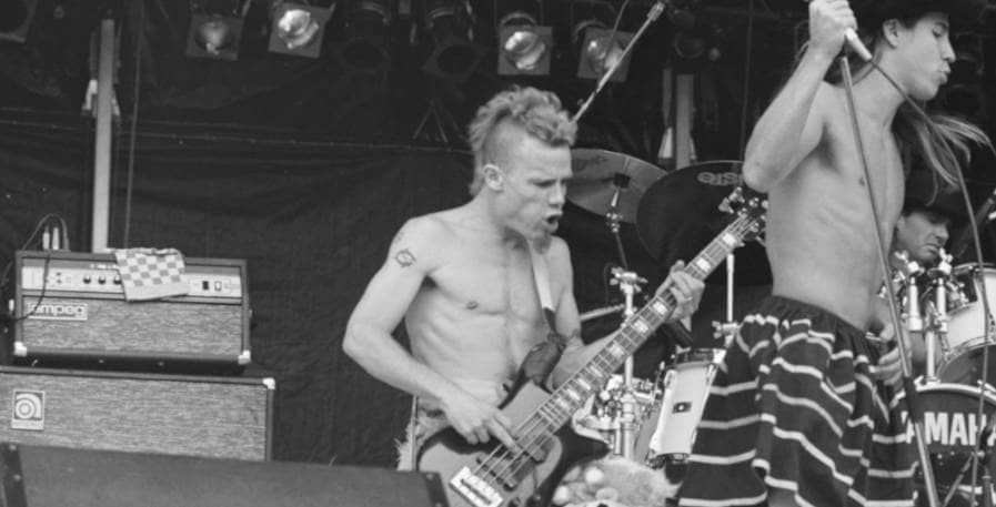 Flea playing bass line with red hot chili peppers live
