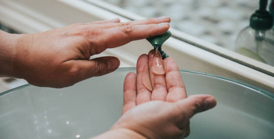 hands being washed with soap