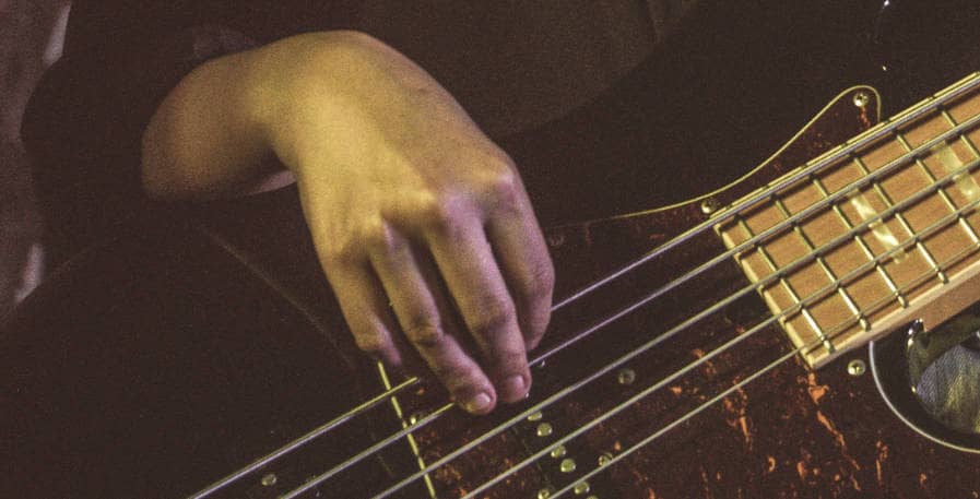 5-string bass guitar being played with small hands