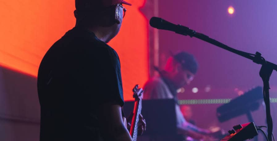 bass player looking over to keyboard player during gig