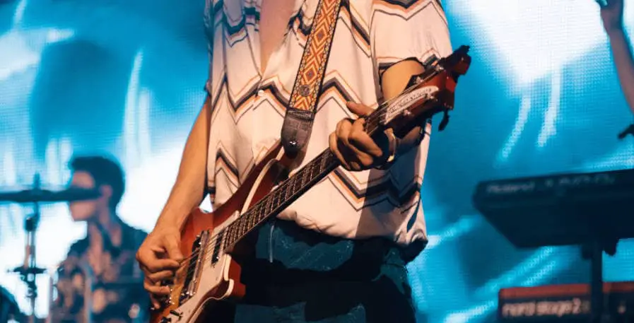bassist playing bass live during a live show