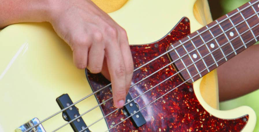 4-string bass guitar being played with fingers