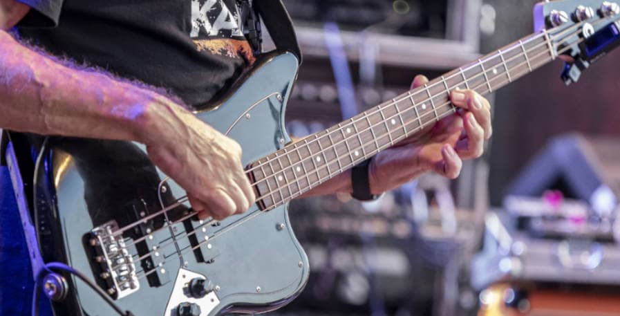 bassist playing bass lick on stage