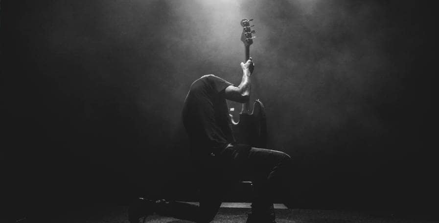 metal bassist playing solo alone on 4-string bass