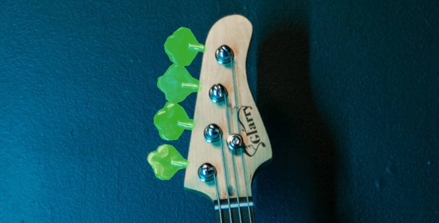 Tuning Pegs on bass guitar headstock highlighted