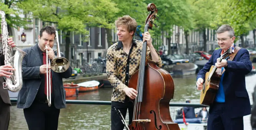 jazz bassist playing double bass with band