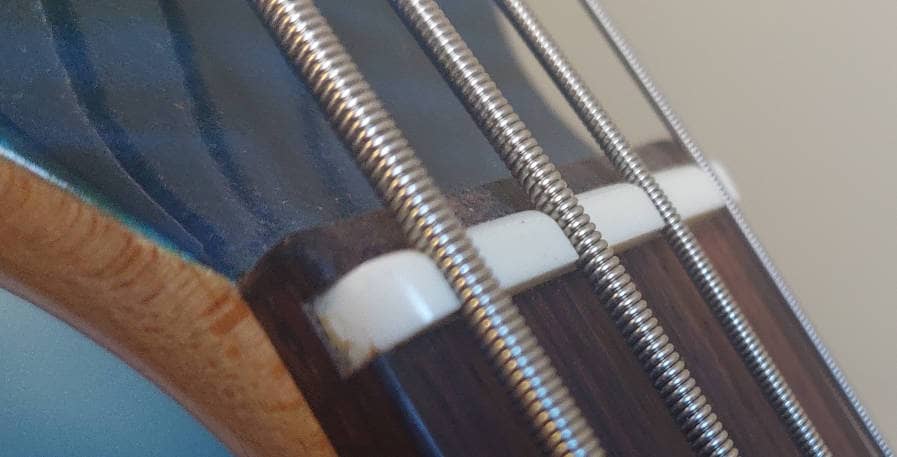 plastic nut on 4-string bass guitar