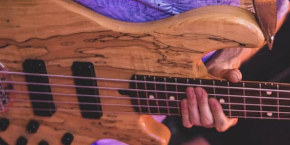 5-string bass guitar held by bassist