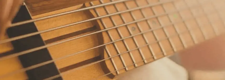 6-string bass guitar being played with fingers