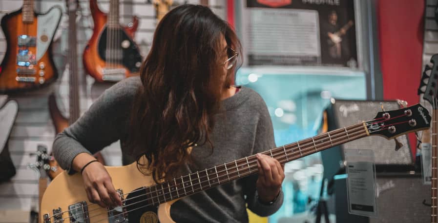 bassist practicing on a 4-string bass guitar