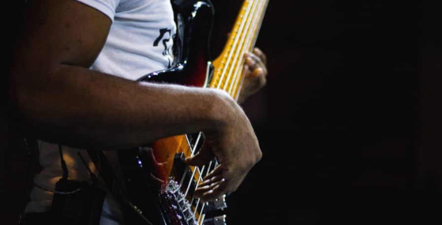 bassist playing fast groove on a 4-string bass guitar